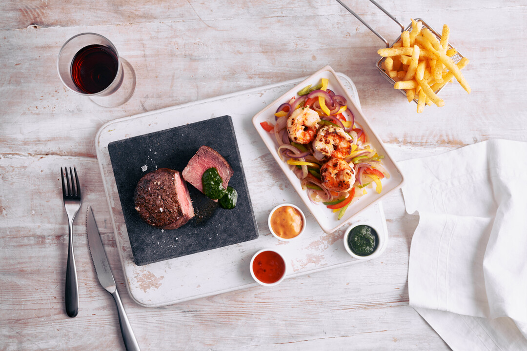 Tuck into American influenced speciality dishes in a fun and informal setting at The Beach House