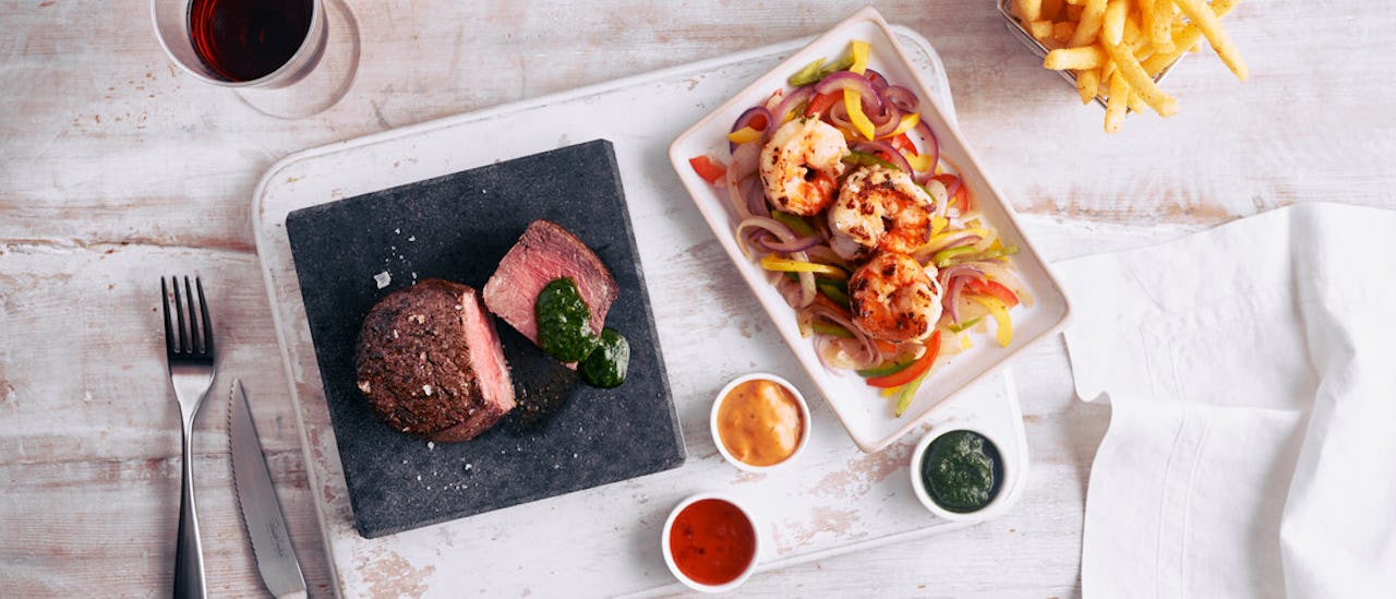 Tuck into American influenced speciality dishes in a fun and informal setting at The Beach House